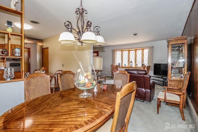 dining area with light colored carpet, visible vents, and a baseboard radiator