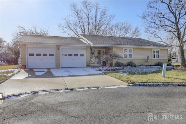 ranch-style home with a front yard and a garage