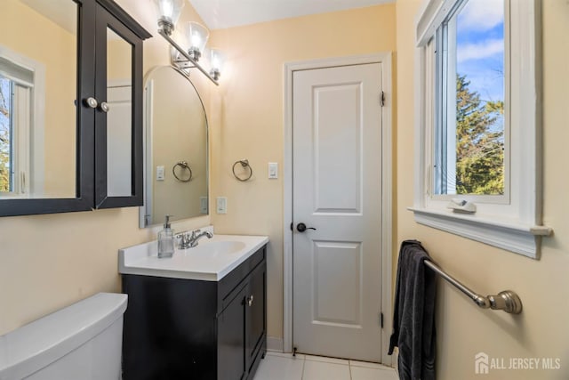 bathroom featuring vanity, tile patterned floors, and toilet