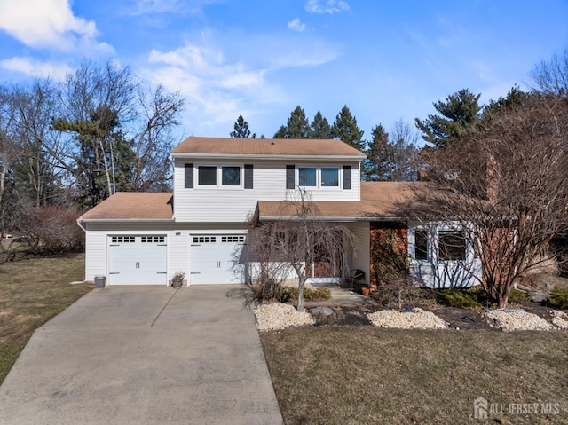 view of property with a garage and a front lawn