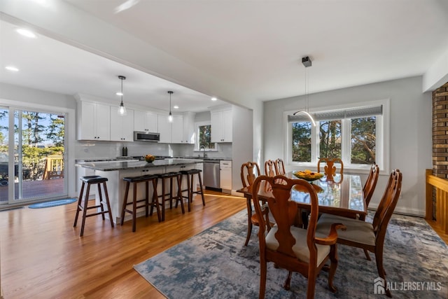 dining room with sink and light hardwood / wood-style floors