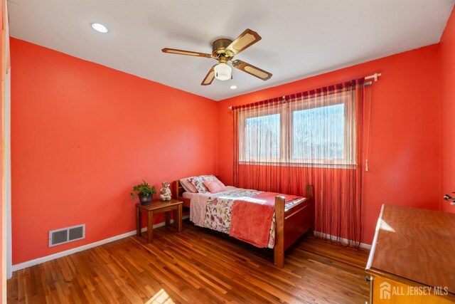 bedroom with wood-type flooring and ceiling fan