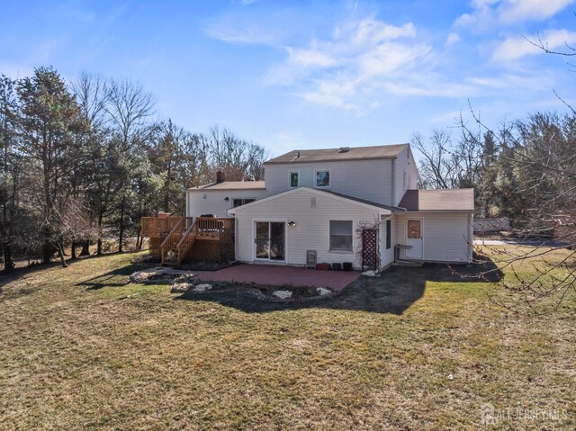 rear view of property with a patio area, a lawn, and a deck