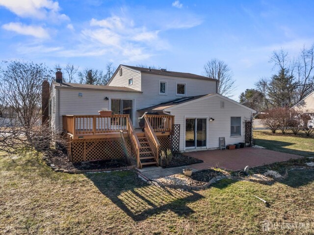 rear view of property with a patio area, a lawn, and a deck