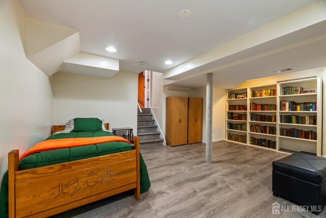 bedroom with wood-type flooring