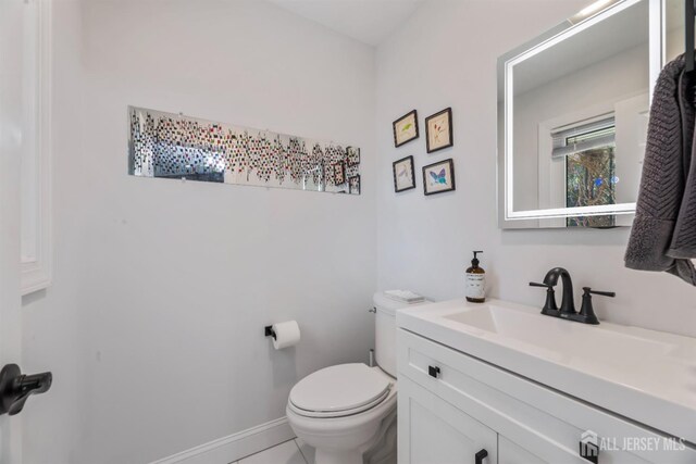 bathroom featuring vanity and toilet