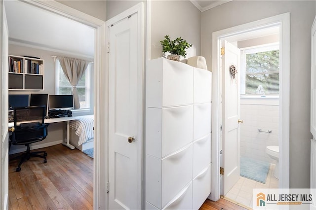 office space with wood-type flooring and ornamental molding