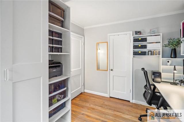 office space with crown molding, light wood-style flooring, and baseboards