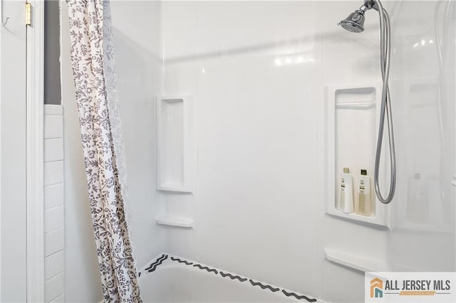full bath with a shower with shower curtain