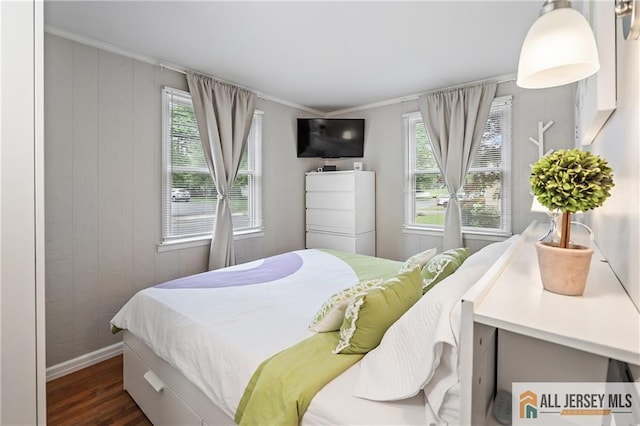 bedroom featuring wood finished floors, baseboards, and ornamental molding