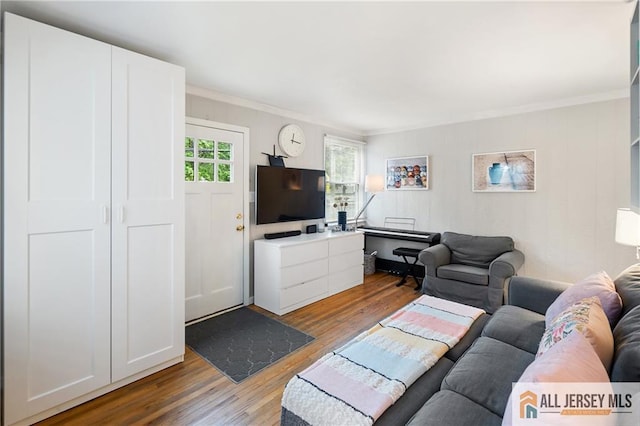 living room with crown molding and wood finished floors
