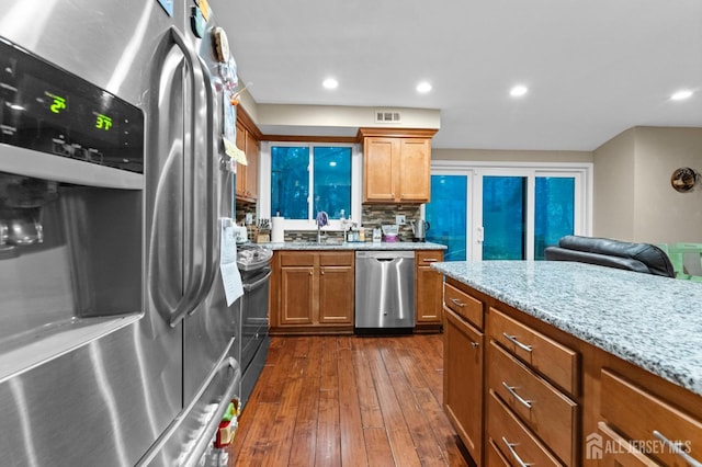 473 E Sayre Dr, Middlesex, NJ 08540 - kitchen featuring appliances with stainless steel finishes, dark wood-style floors, light stone counters, brown cabinets, and recessed lighting