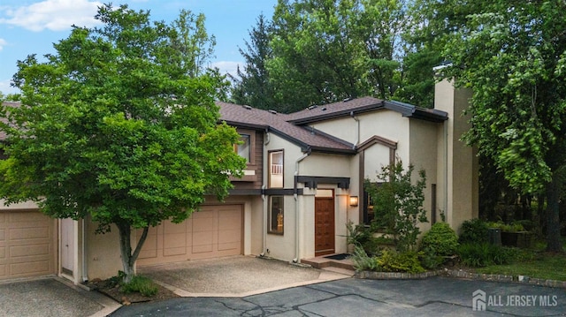 473 E Sayre Dr, Middlesex, NJ 08540 - view of front of home featuring asphalt driveway, stucco siding, and a garage