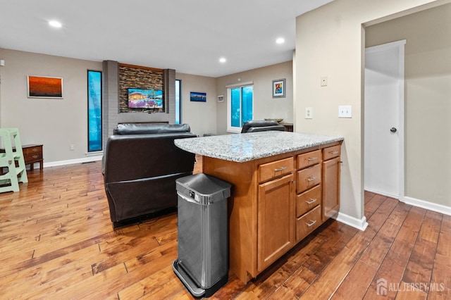 473 E Sayre Dr, Middlesex, NJ 08540 - kitchen with open floor plan, light wood-type flooring, recessed lighting, brown cabinetry, and light stone counters