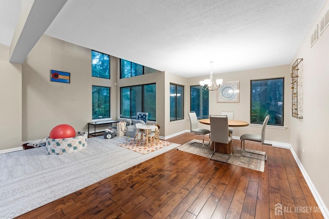 473 E Sayre Dr, Middlesex, NJ 08540 - dining space featuring hardwood / wood-style floors, a chandelier, and a textured ceiling
