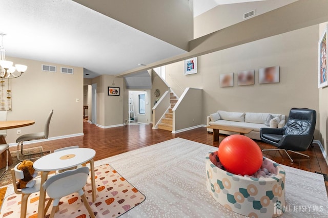 473 E Sayre Dr, Middlesex, NJ 08540 - living area featuring wood finished floors, stairway, and a chandelier