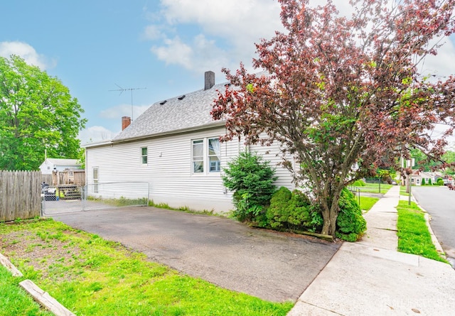21 Suydam Ave, Edison, NJ 08817 - view of property exterior featuring a chimney, asphalt driveway, and a shingled roof