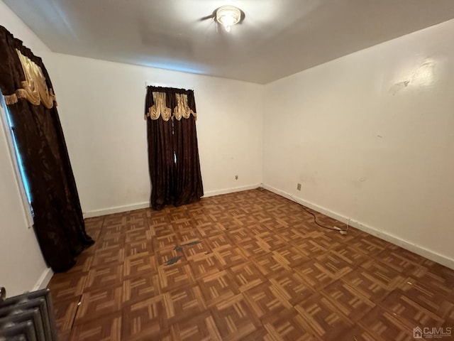 empty room featuring dark parquet floors