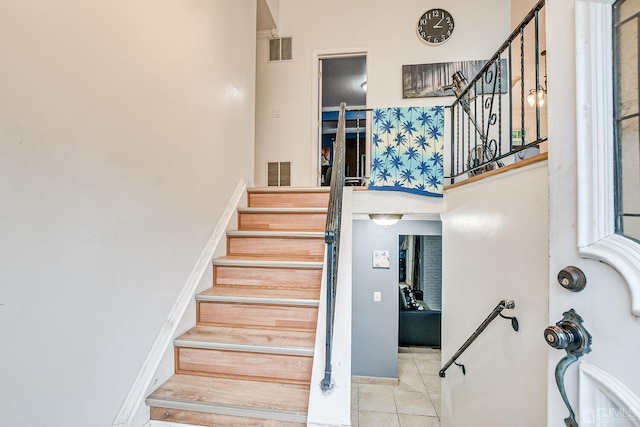 stairway featuring tile patterned flooring