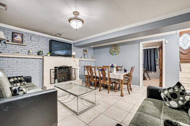 living room featuring ornamental molding, light tile patterned floors, and a fireplace