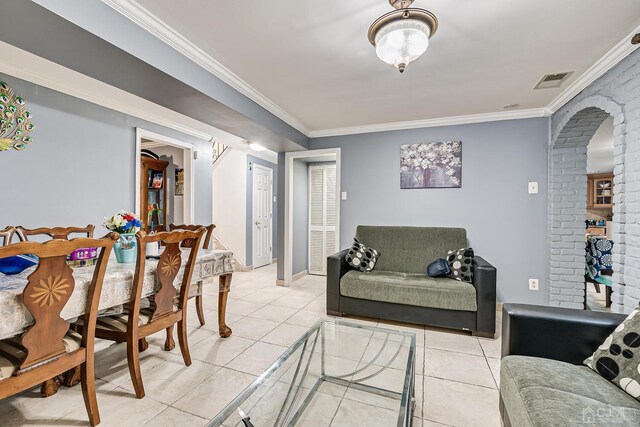 living room featuring crown molding and light tile patterned floors