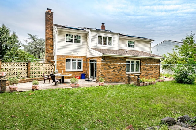 rear view of house featuring a yard, an outdoor fire pit, and a patio area