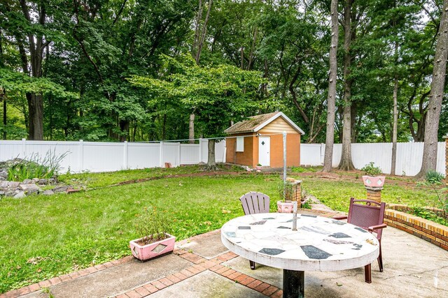 view of patio / terrace with an outdoor fire pit and a shed