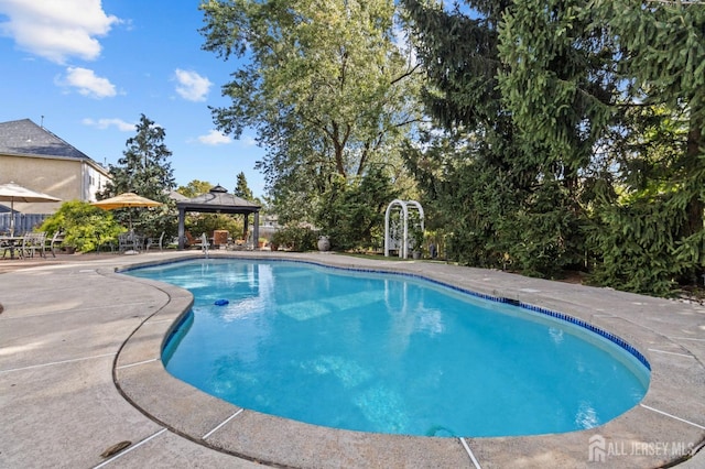 pool with a gazebo and a patio area