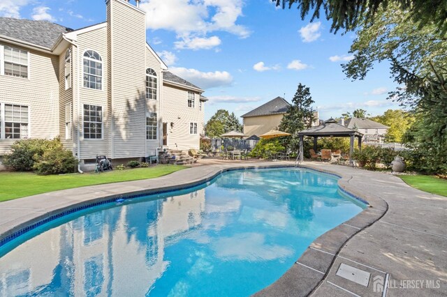 pool featuring entry steps, a gazebo, a yard, and a patio