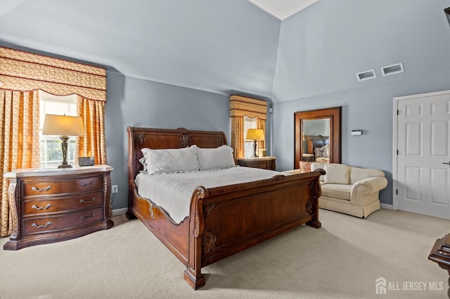 bedroom with visible vents, light carpet, baseboards, and vaulted ceiling