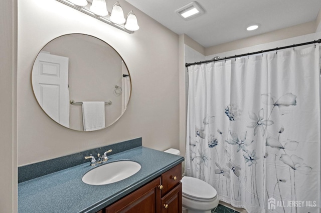 bathroom with vanity, a shower with shower curtain, toilet, and visible vents