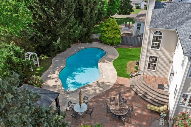 view of swimming pool featuring a fenced backyard, a fenced in pool, and a patio