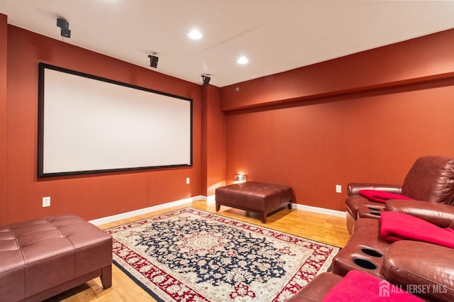 cinema room featuring recessed lighting, wood finished floors, and baseboards