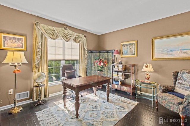 home office featuring visible vents, baseboards, and wood finished floors