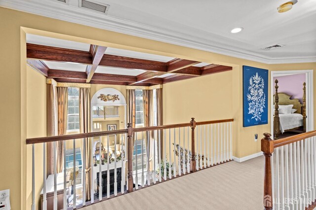 hall featuring visible vents, coffered ceiling, beamed ceiling, and carpet flooring