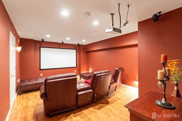 home theater with recessed lighting and light wood-style flooring