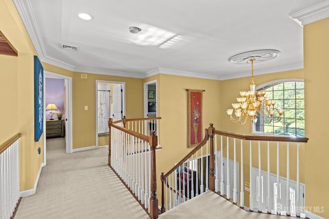 corridor featuring baseboards, carpet, ornamental molding, an upstairs landing, and an inviting chandelier