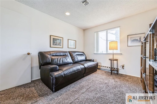 159 Pitman Rd Unit C, Monroe, NJ 08831 - carpeted living room featuring a textured ceiling, a baseboard heating unit, and recessed lighting
