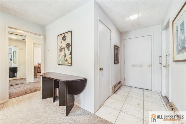 159 Pitman Rd Unit C, Monroe, NJ 08831 - corridor featuring a textured ceiling, marble finish floor, and baseboard heating