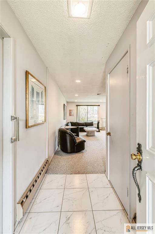 159 Pitman Rd Unit C, Monroe, NJ 08831 - hallway with baseboard heating, a textured ceiling, and marble finish floor