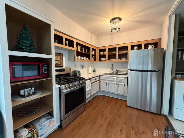 4 Nebraska Dr Unit C, Old Bridge, NJ 07747 - kitchen with appliances with stainless steel finishes, open shelves, washer / clothes dryer, wood finished floors, and light countertops