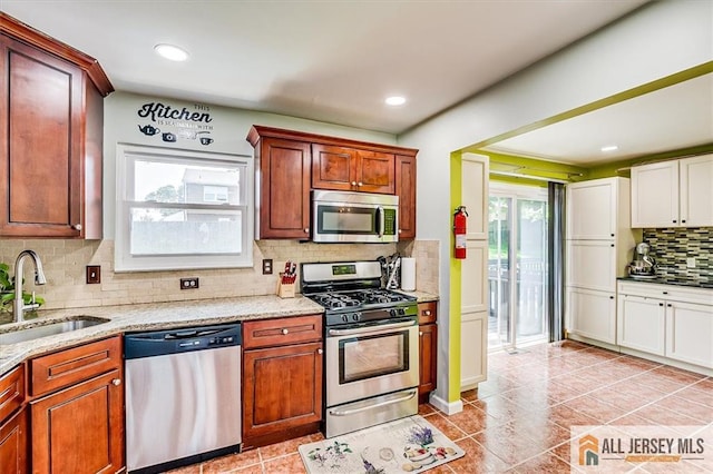 907 Maple Hill Dr Unit 907, Woodbridge Proper, NJ 07095 - kitchen featuring appliances with stainless steel finishes, tasteful backsplash, light stone countertops, light tile patterned floors, and recessed lighting