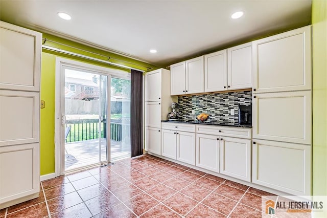 907 Maple Hill Dr Unit 907, Woodbridge Proper, NJ 07095 - kitchen with light tile patterned flooring, tasteful backsplash, dark countertops, recessed lighting, and white cabinetry