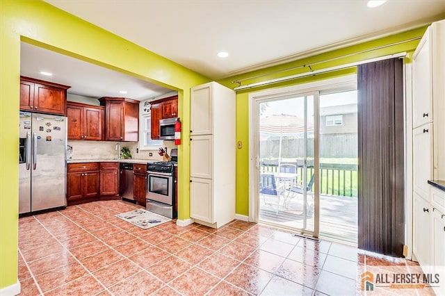 907 Maple Hill Dr Unit 907, Woodbridge Proper, NJ 07095 - kitchen with appliances with stainless steel finishes, backsplash, recessed lighting, light tile patterned floors, and light countertops