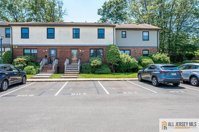 907 Maple Hill Dr Unit 907, Woodbridge Proper, NJ 07095 - view of front of house featuring uncovered parking and brick siding