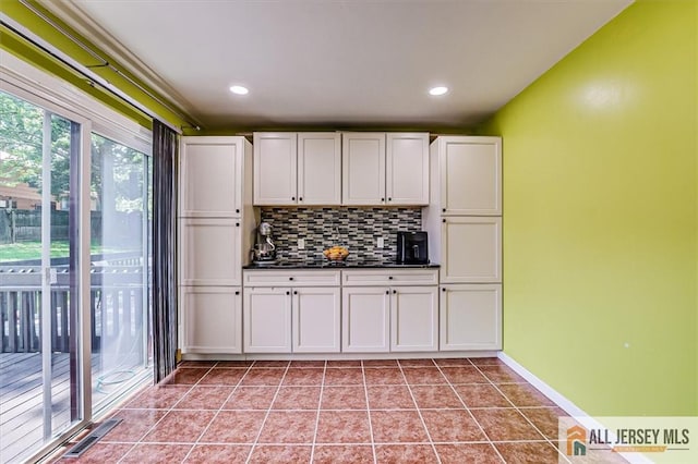 907 Maple Hill Dr Unit 907, Woodbridge Proper, NJ 07095 - kitchen with dark countertops, tasteful backsplash, white cabinets, light tile patterned floors, and recessed lighting
