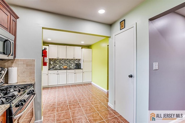 907 Maple Hill Dr Unit 907, Woodbridge Proper, NJ 07095 - kitchen with stainless steel appliances, backsplash, white cabinetry, recessed lighting, and light tile patterned flooring