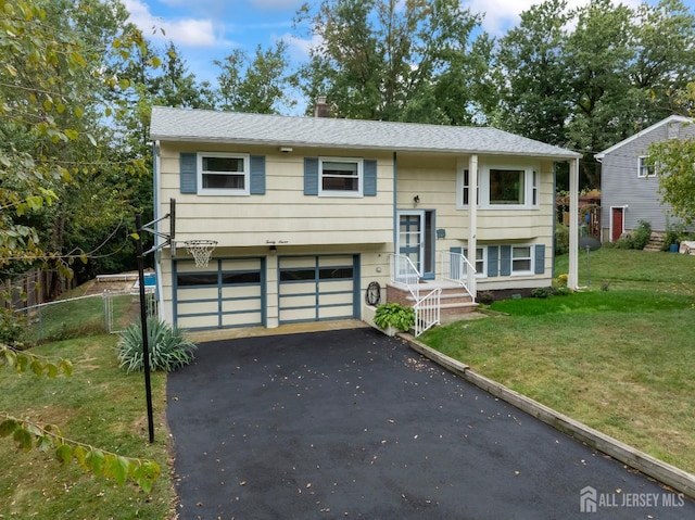 bi-level home featuring a front yard and a garage