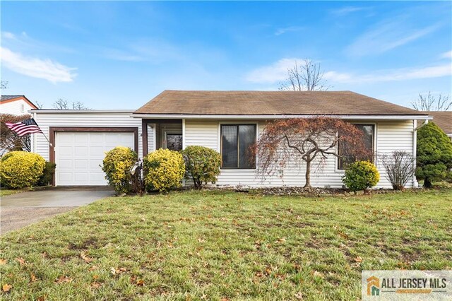 single story home featuring a front lawn and a garage