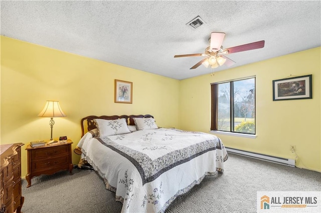 carpeted bedroom featuring a baseboard heating unit, a textured ceiling, visible vents, and a ceiling fan